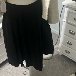 Black pleated A-line skirt.
